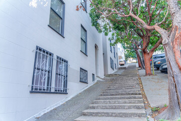 Concrete steps on a sloped side walk near the buildings in San Francisco, California