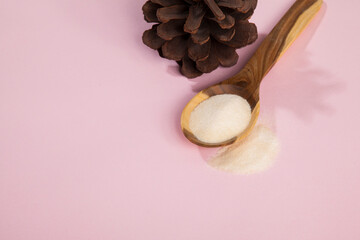Collagen powder on pink background.