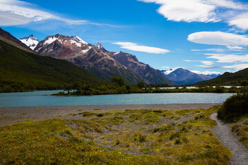 Fototapeta na wymiar River in valley at foot of mountains and glaciers Fitz Roy, Cerro Torre. Patagonia, Argentina, Chile, Andes