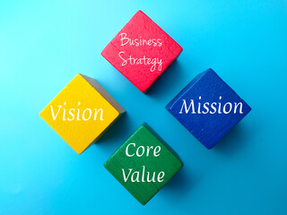 Top view colored wooden block with the word for Business Strategy. Core values, vision and mission