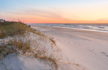 Fototapeta na wymiar Beautiful sunrise over Kure Beach, Kure Beach, North Carolina USA. Kure Beach is a town 15 miles south of Wilmington, North Carolina