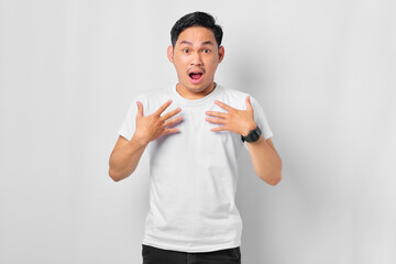 Shocked young Asian man with open mouth and looking at camera isolated on white background