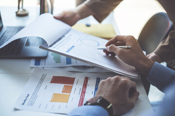 Consult financial concept. Business woman pointing at paperwork and using calculator.