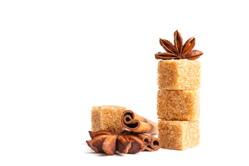 Anise stars, cinnamon sticks and brown sugar  isolated on white background. Cooking ingredients close-up