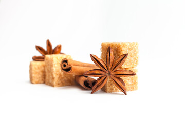 Anise stars, cinnamon sticks and brown sugar  isolated on white background. Cooking ingredients close-up