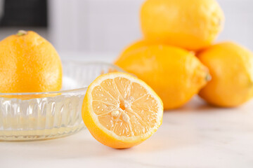 A Lemon Being Juiced on a Kitchen Counter