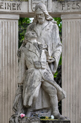 Obraz premium A monument to Jesus holding a wounded soldier in his arms at the Pecs cemetery - Hungary