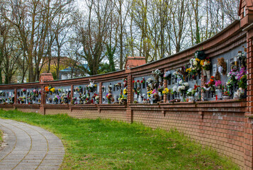 the wall where the urns of the cremated people are buried in the cemetery of the city of Pecs - Hungary - obrazy, fototapety, plakaty