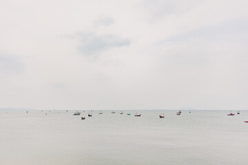 Cloudy day of tropical sea with many local fishing boats.