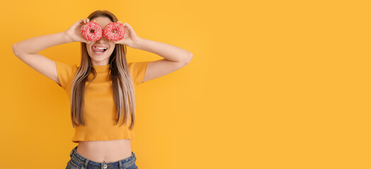 Funny young woman with tasty donuts on orange background with space for text