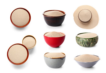 Set of bowls with dry yeast on white background