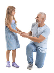 Little girl with her grandfather holding hands on white background