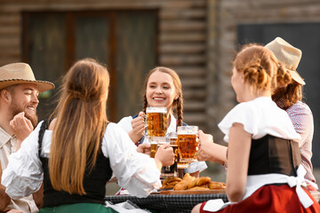 People with beer celebrating Octoberfest outdoors