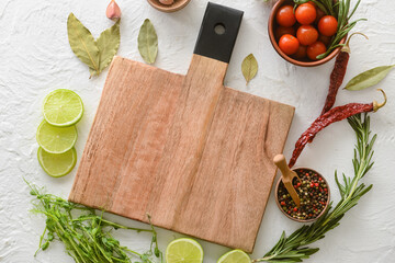 New cutting board with lime, tomatoes and spices on light background