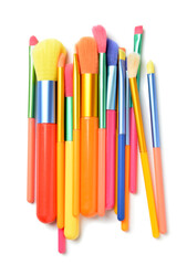 Set of colorful makeup brushes on white background