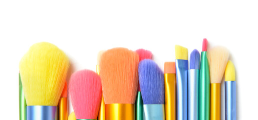 Set of colorful makeup brushes on white background, closeup