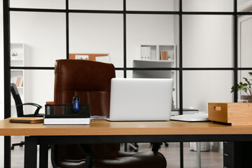 Workplace with modern laptop in office