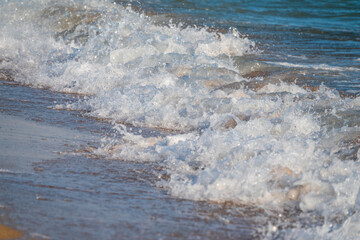 Soft wave of the sea on the sandy beach.