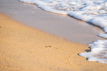 Soft wave of the sea on the sandy beach.