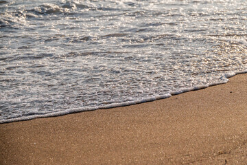 Soft wave of the sea on the sandy beach.