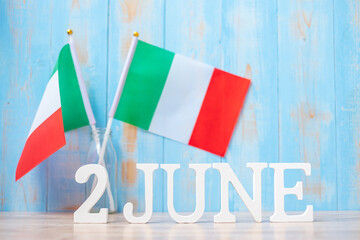 Fototapeta na wymiar Wooden text of June 2nd with Italy flags. National Day, Republic Day, Festa della Repubblica and happy celebration concepts