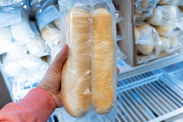 Frozen bread in the refrigerator. ciabatta, loaf, hamburger buns