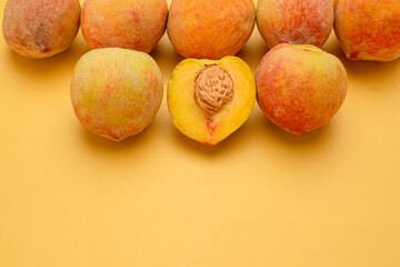 Pile of fresh peaches fruit over a yellow background
