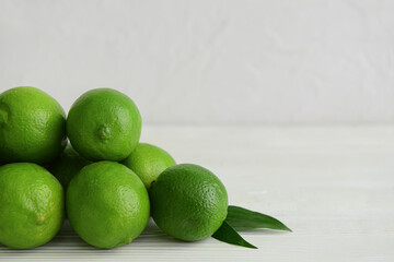 Pile of fresh limes on table, closeup