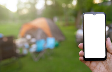 smart phone on the blur background of camping tent