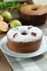 Brazilian corn cake made with a type of corn flour (Fuba) filled with guava paste. On a wooden party table. Typical sweets of the June festival. Cornmeal cake