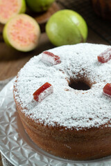 Brazilian corn cake made with a type of corn flour (Fuba) filled with guava paste. On a wooden party table. Typical sweets of the June festival. Cornmeal cake