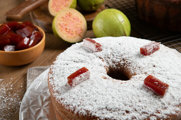 Brazilian corn cake made with a type of corn flour (Fuba) filled with guava paste. On a wooden party table. Typical sweets of the June festival. Cornmeal cake