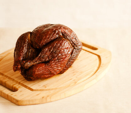 Whole Smoked Turkey on a Cutting Board.