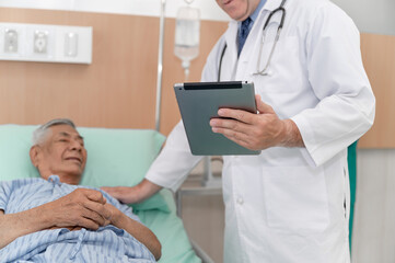 Obraz premium Doctor use tablet with hand touch patient at hospital