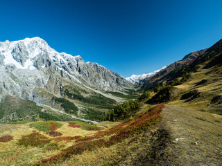 Panoramic view of valley Valle d'Aosta with beautiful mountains landscape in the background and blue sky above. Autumn in the Pennine Alps, Valle d'Ao