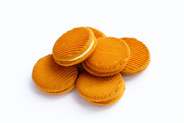 Custard cream sandwich biscuits on white background.