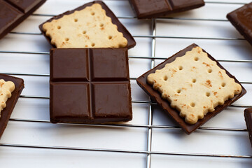 Square biscuits in dark chocolate
