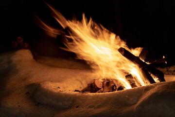 campfire in snow windy weather
