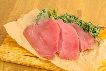 Raw salted tuna slice over board