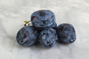 Ripe plum heap over background