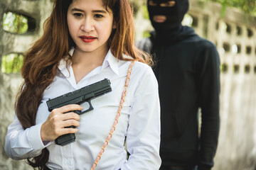 Young woman self defence putting gun in her small handbag, female hide gun in his chest, self-defense criminal concept