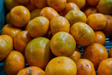 Mandarins put on a shelf for sale within a market