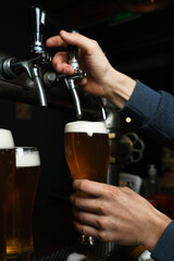 Fototapeta na wymiar bartender pouring beer