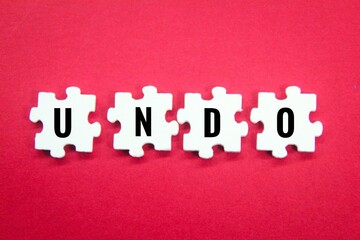 wooden puzzle with the word undo. cancel the draft