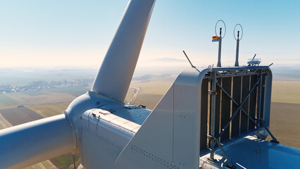 Aerial view of close up windmill turbine in countryside area, Wind power and renewable sustainable...