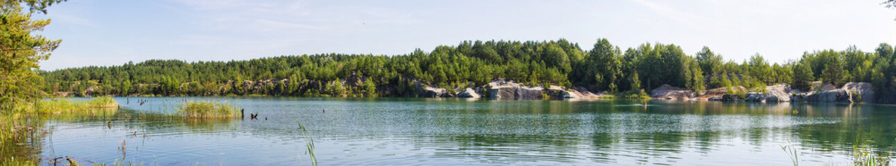 Fototapeta na wymiar Ukraine Korostyshev granite quarry Blue lake in the forest