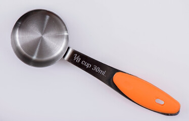 Measuring Cups and Spoons, on a white background. 1⁄8 cup 30mL.