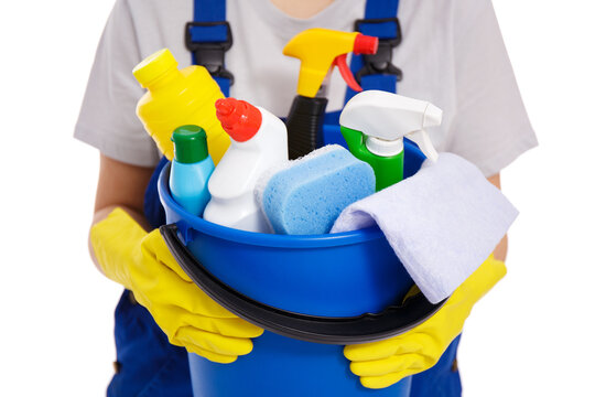 hands in yellow gloves holding blue bucket with cleaning equipment isolated on white background