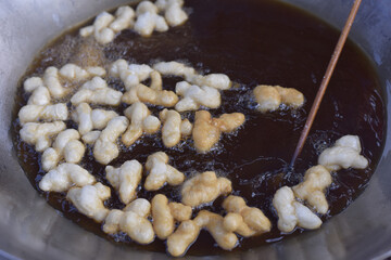 Patongko or deep-fried dough sticks, traditional morning snack or breakfast of Thai and Chinese, close up Patongko or deep-fried dough sticks.