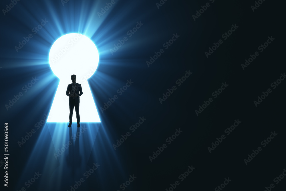 Poster Backlit business man standing in bright keyhole opening on dark background with mock up place and light rays. Dream, future and opportunity concept.